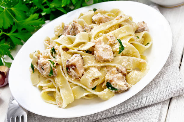 istock Pasta with salmon and cream on white board 1290994442