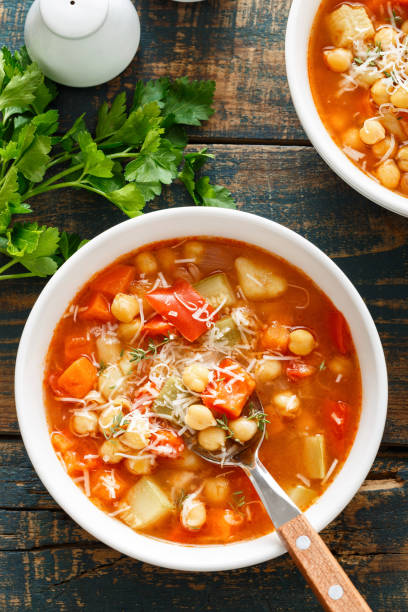 istock Vegetables soup bowl. Tuscan tomato chickpea soup with various vegetables, thyme and parmesan cheese. 1290996383