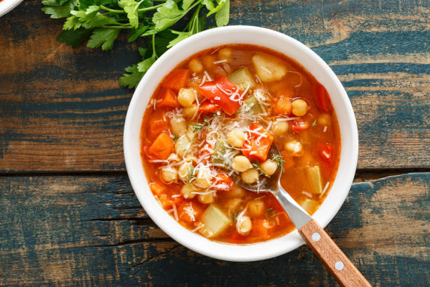 istock Vegetables soup bowl. Tuscan tomato chickpea soup with various vegetables, thyme and parmesan cheese. 1290996384