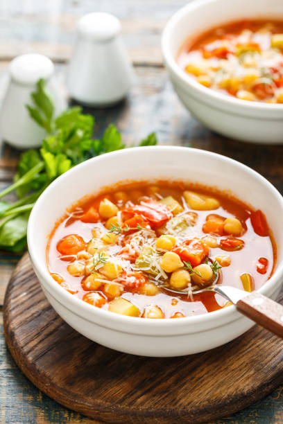istock Vegetables soup bowl. Tuscan tomato chickpea soup with various vegetables, thyme and parmesan cheese. 1290996433
