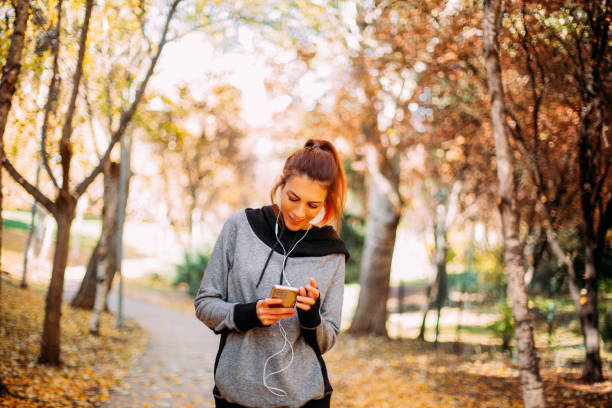 istock Woman Resting After Exercise, Checking Her Smartphone at Park 1290997665