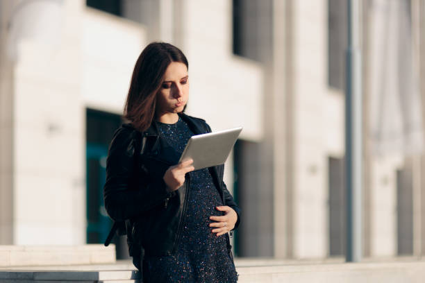 istock Stressed Working Pregnant Woman Holding a PC Tablet 1291000046