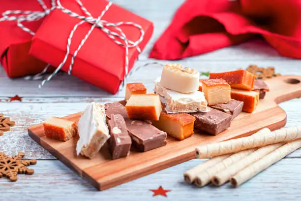 Traditional Spanish Christmas sweets turron, polvorones, mantecados on grey table top