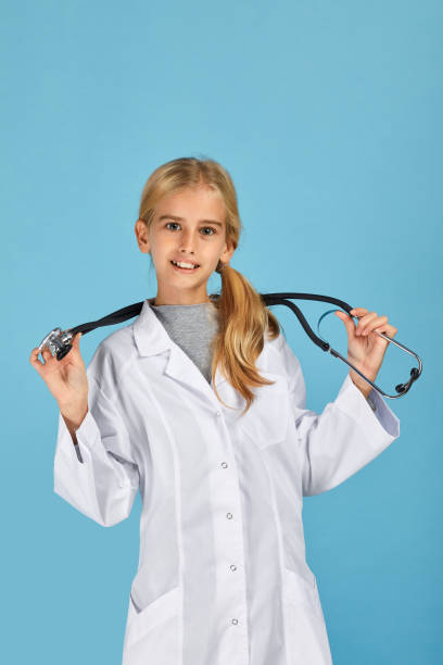 istock Cute child in doctor coat with stethoscope 1291001194