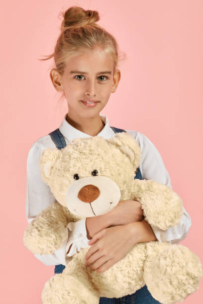 istock cute little girl is hugging a teddy bear 1291001618