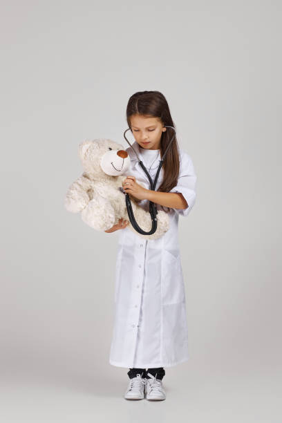 istock Cute child in doctor coat with stethoscope 1291001951
