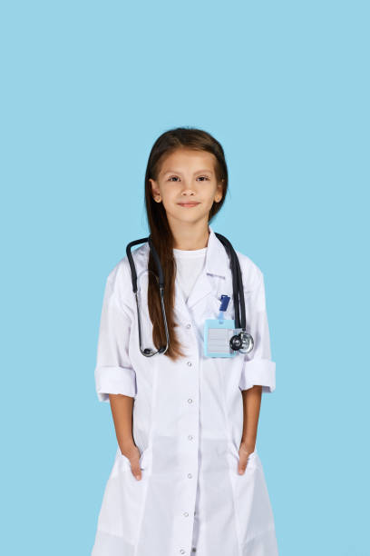 istock Cute child in doctor coat with stethoscope 1291002600