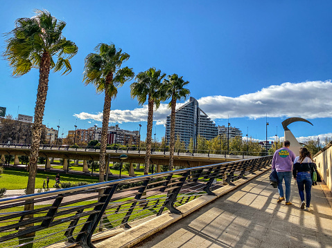 Valencia, Spain - December 8, 2020: Couple walking their way out of the Turia Garden. This dried riverbed converted into a public park is the perfect place to take a city break and get in contact with nature