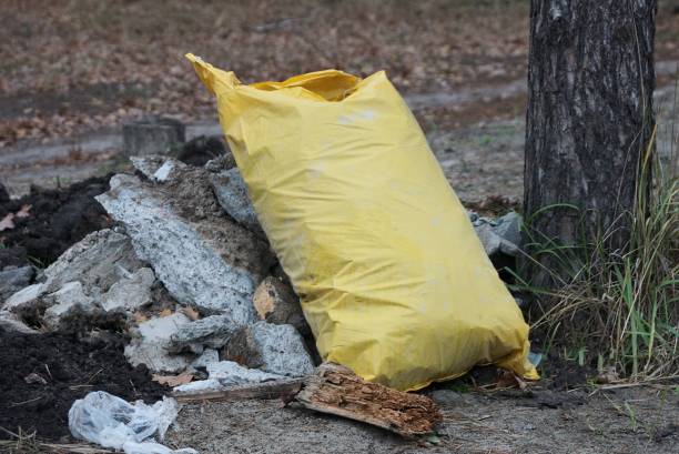 istock one large plastic yellow garbage bag stands on gray ground 1291003191