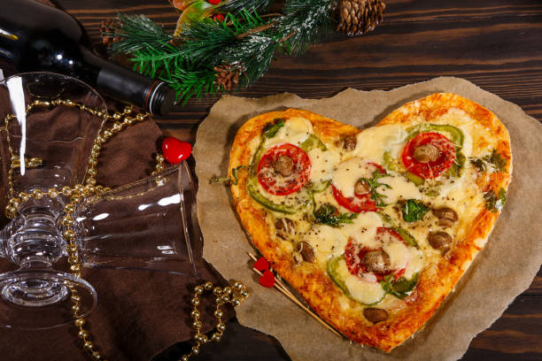 istock Heart-shaped pizza and merry Christmas 1291003418