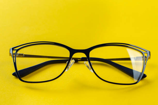 istock Stylish glasses for correcting vision on a yellow background. Fashionable accessory. 1291004293