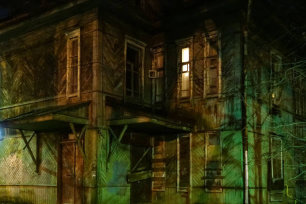 istock Abandoned creepy wooden house with a glowing window. Horror 1291004716