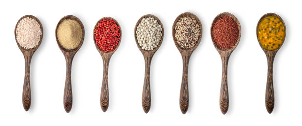 istock brown rice, brown sugar, red pepper, mixed raw quinoa, white beans, red quinoa, passion fruit in wood spoon isolated on white background 1291005934