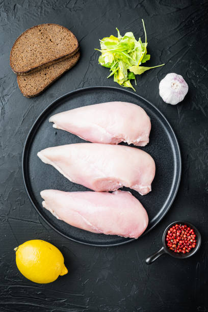 istock Crispy garlicky chicken raw ingredients, on black background, top view 1291007026