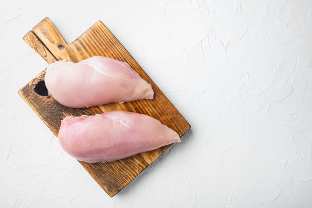 istock Chicken raw fillet on white background, top view with space for text 1291008168