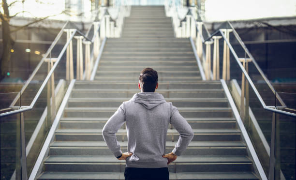 istock Man in hoodie preparing for stair run. 1291008207