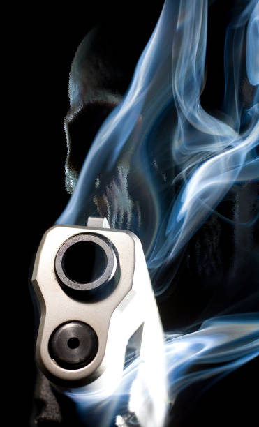 istock 3D rendering on a ghost gun with a skull behind smoke rising from a handgun barrel 1291011858