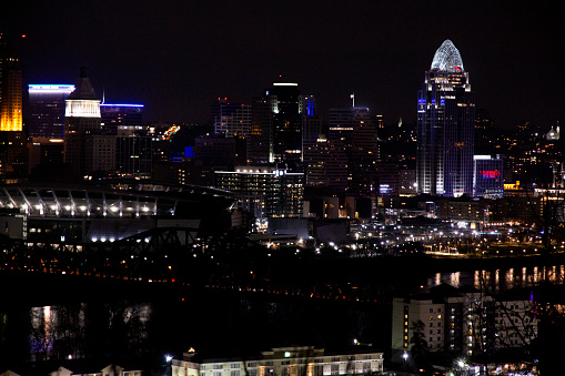 A nighttime scene of the night lights of Cincinnati Ohio. The image is shot from Devou Park.