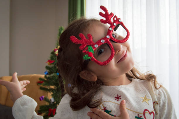 istock Child girl with Christmas tree 1291017968