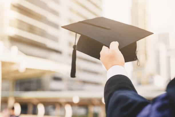istock Students hold a hat in their hands during the university's successful graduation. 1291023567