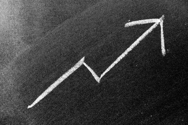 istock White chalk draw as upward arrow graph on black board background (Concept for sale, profit, cost of company in uptrend) 1291024107