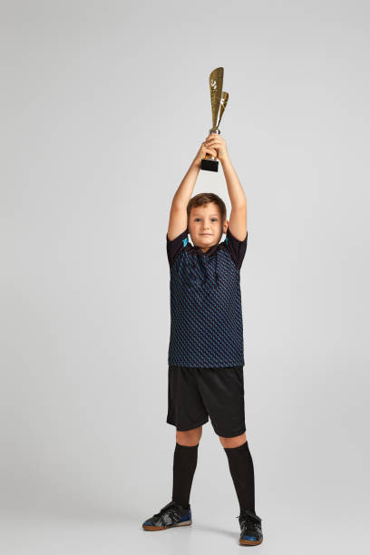 istock Football player holding a golden cup 1291025007