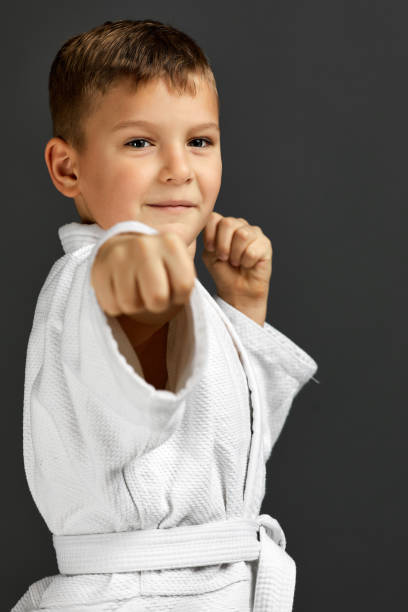 istock boy dressed in a white karate kimono 1291025989