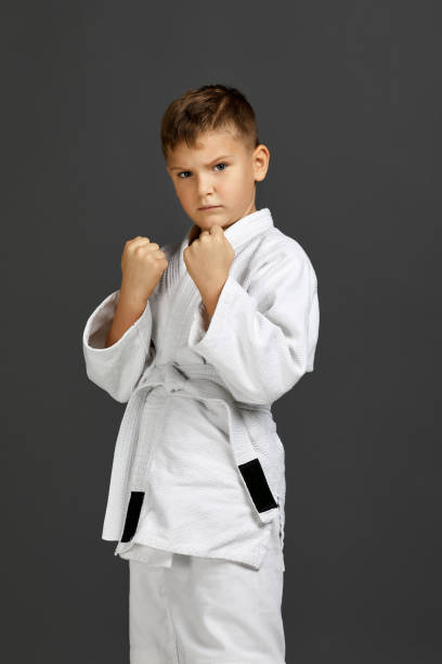 istock boy dressed in a white karate kimono 1291026354