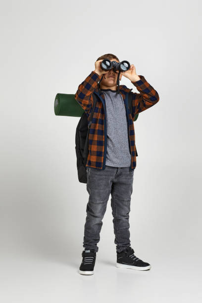istock Little boy tourist with binoculars 1291026859