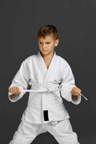 istock boy dressed in a white karate kimono 1291026916