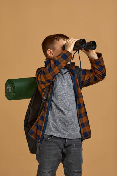 istock Little boy tourist with binoculars 1291027362