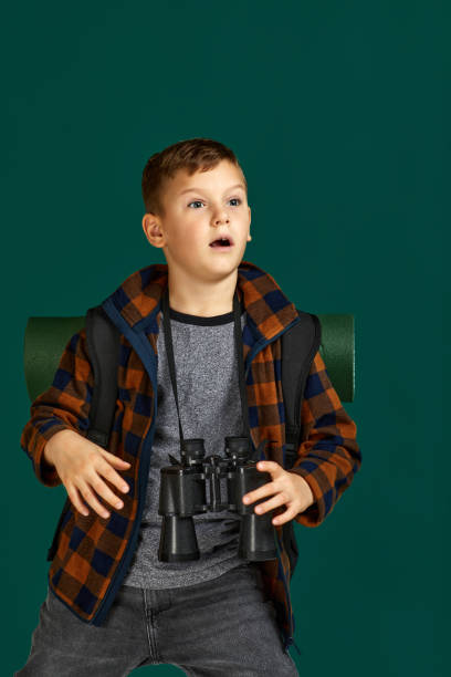 istock Little boy tourist with binoculars 1291027590