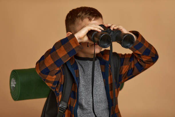 istock Little boy tourist with binoculars 1291028281