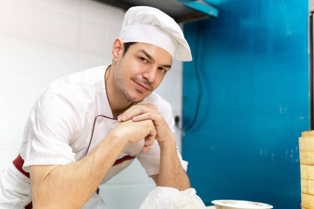istock Portrait of young male chef in kitchen. 1291028480