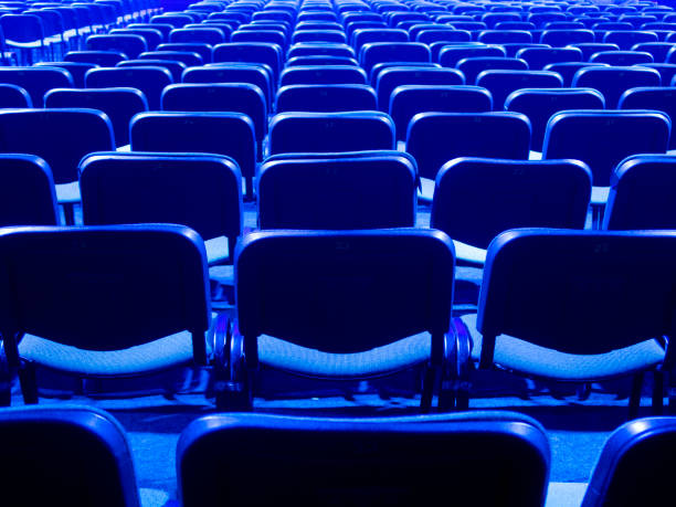 istock Blue chairs are placed on a row in an auditorium 1291029887