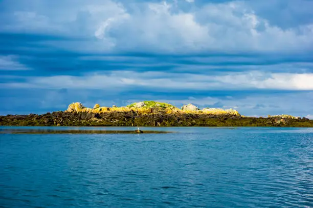 Photo of Small rocky islands on the horizon in the archipelago of Iles de Chausey. Brittany, France.