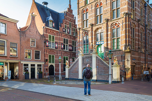 Culemborg, Netherlands - November 6, 2020: Tourist enjouying the architecture of the City hall of Culemborg, municipality in Gelderland in the Netherlands