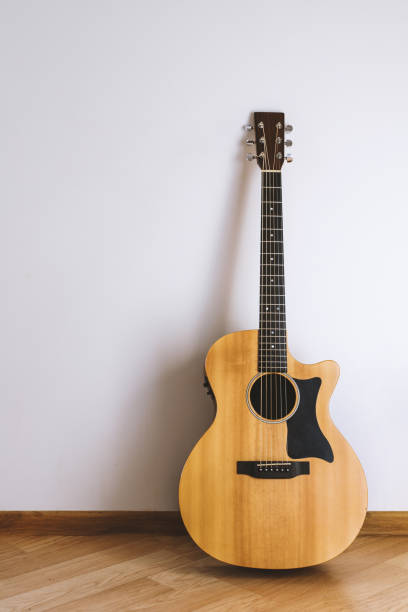 istock Acoustic guitar against the wall. 1291039567