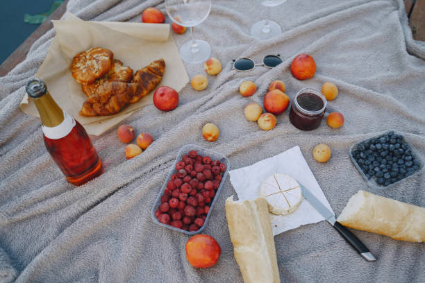 istock Picnic set with fruit and cheese and wine on a blanket 1291042040
