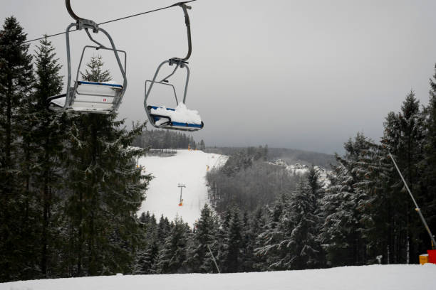 Snowed-in chairlift on the ski slopes Winterberg, NRW, Germany - 12.07.2020 : Snowed-in chairlift on the ski slopes closed by the corona lockdown, Winterberg, Sauerland. winterberg photos stock pictures, royalty-free photos & images