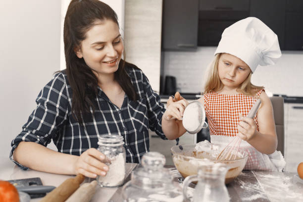 istock Family in a kitchen cook the dough for cookies 1291043143