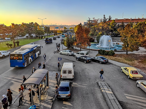 Turkey, Ankara - October 23, 2019: Top view of Etlik Cd street in Ankara. City life in the Turkish capital.  Lots of people on the street with public transport, cars, park, fountain and bus stop