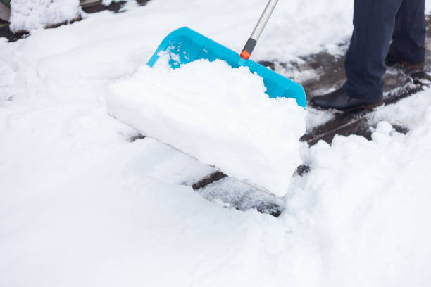 istock A man cleans the snow with a big blue shovel 1291044632