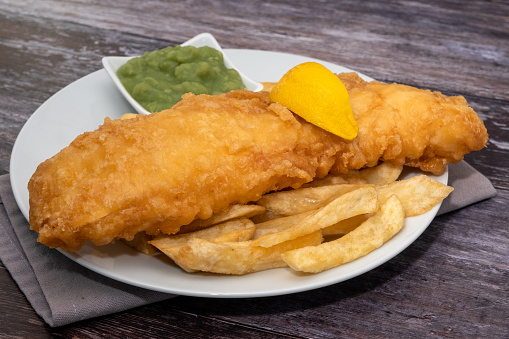 Fried battered cod with french fries and mushy peas