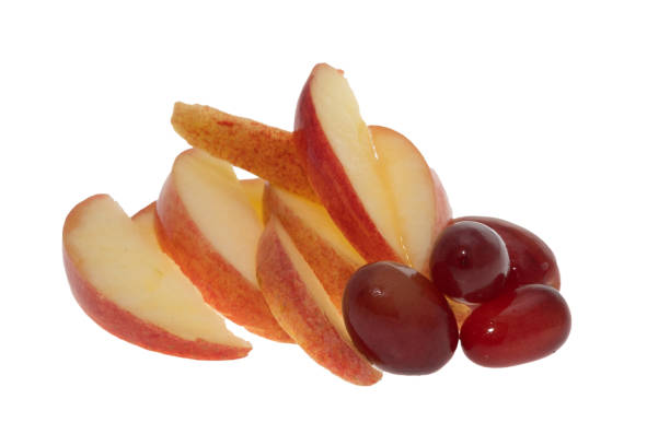 Slices of apple with grapes - white background
