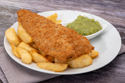 Fried breaded cod with french fries and mushy peas
