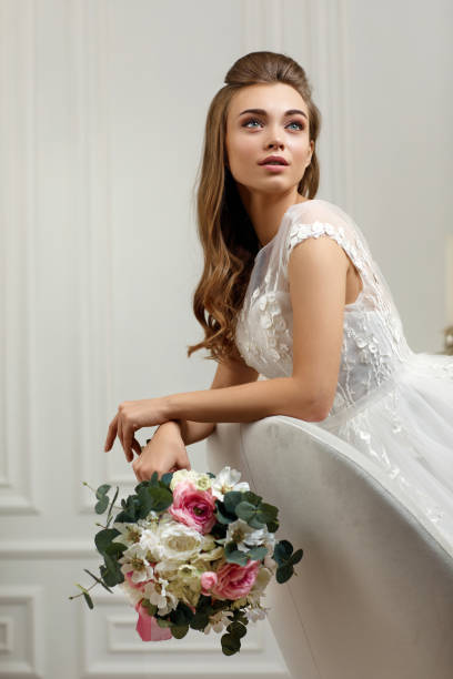 istock beautiful tender young bride with flower bouquet 1291045520