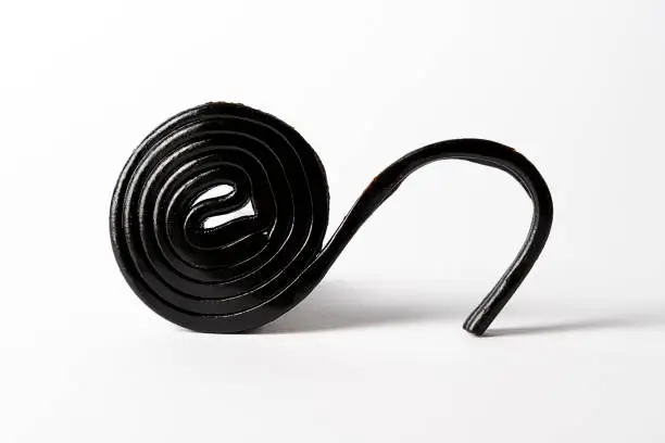 Roll spiral of black licorice isolated on white background