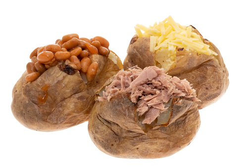 Jacket potatoes with three different fillings, cheese, tuna, baked beans - white background
