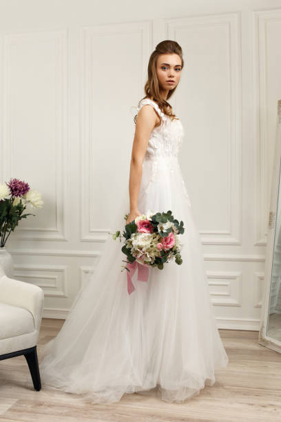 istock beautiful tender young bride with flower bouquet 1291045661